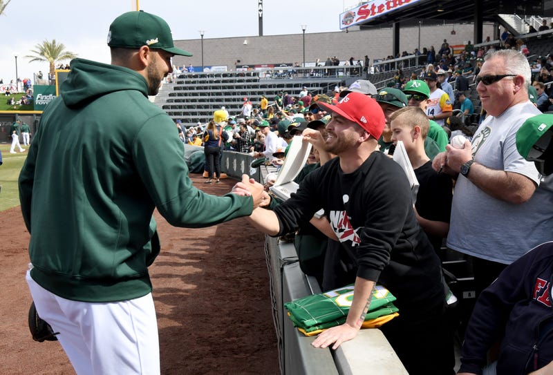 A member of the Oakland A's greets a fan at Las Vegas Ballpark