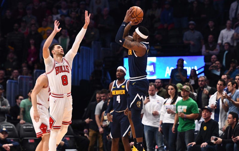 Nuggets forward Torrey Craig (3) attempts a 3-pointer over Bulls guard Zach LaVine (8).