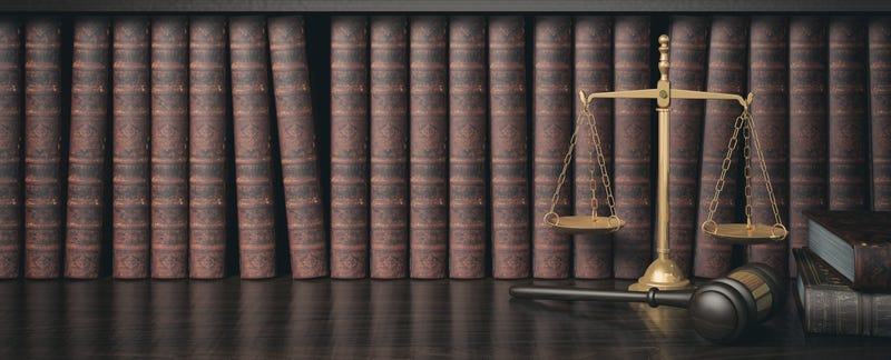 Low key filter law bookshelf with wooden judge's gavel and golden scale