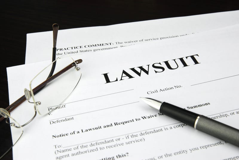 lawsuit form with glasses and pen