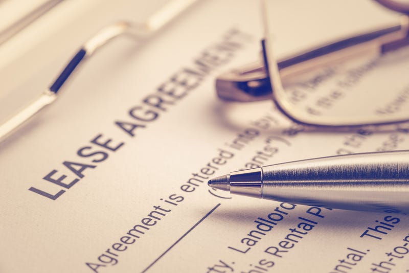 Business legal document concept: pen and glasses on a lease agreement form