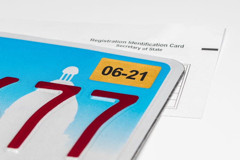 License plate corner with sticker and registration paper