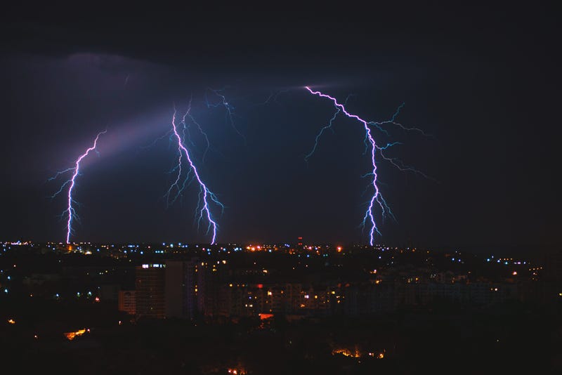 Photo of lightning over big city