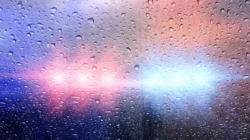 Police vehicle with lights and raindrops - stock photo