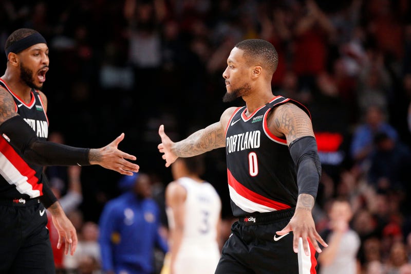 Damian Lillard high-fives Carmelo Anthony