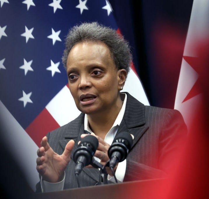 Lori Lightfoot at public appearance, U.S. flag in background