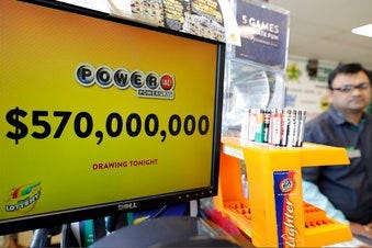 FILE - In this Jan. 6, 2018 file photo, a Powerball lottery sign displays the lottery prizes at a convenience store in Chicago. Lottery jackpots are going to shrink as the coronavirus pandemic tamps down lottery sales. (AP Photo/Nam Y. Huh File)