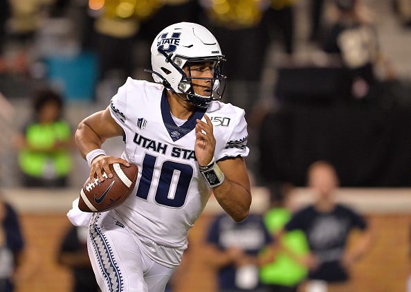 Jordan Love rolls out to make a play with Utah State. 
