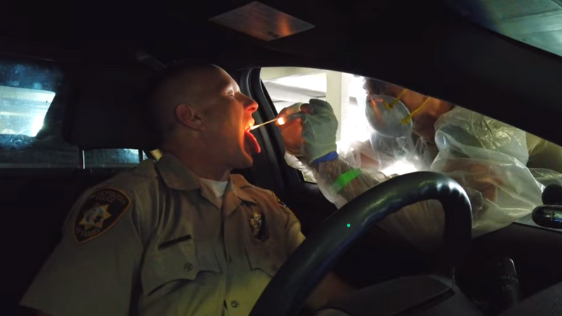 A Las Vegas Metro Police officer takes a COVID-19 test