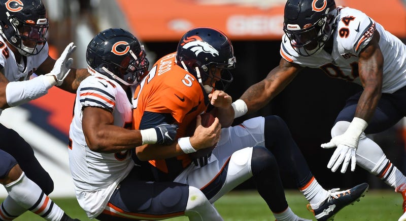 Bears outside linebacker Khalil Mack (52) and outside linebacker Leonard Floyd (94) sack Broncos quarterback Joe Flacco (5).