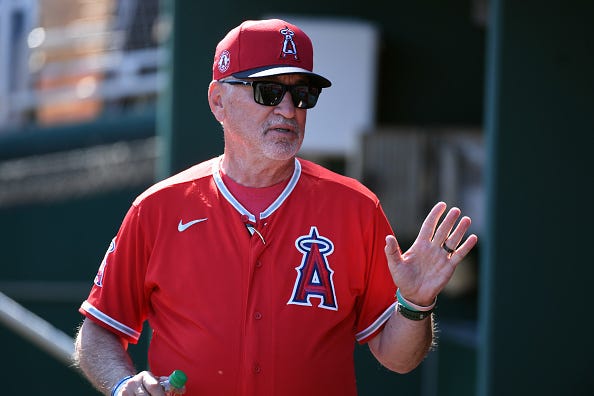 Joe Maddon talks in the Angels dugout. 