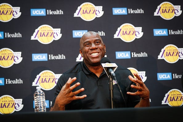 Magic Johnson speaks with reporters at a press conference.