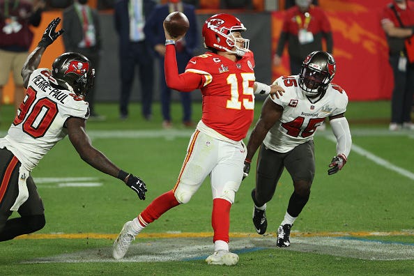Patrick Mahomes fires a pass under pressure.