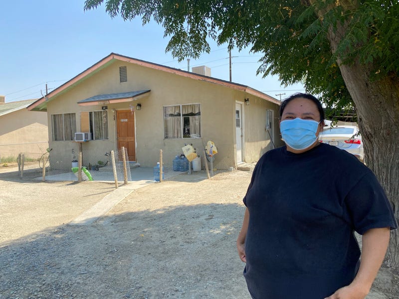 Maria Sanchez outside her home in Cantua Creek