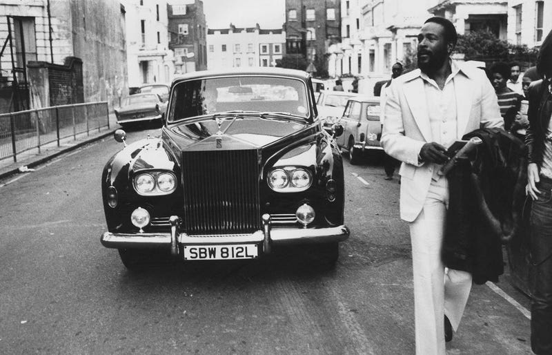 6th October 1976: American soul singer Marvin Gaye (1939 - 1984) walking ahead of his Rolls Royce in Notting Hill, London
