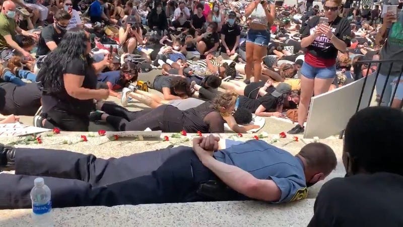 Massachusetts police chief lies face down with protesters
