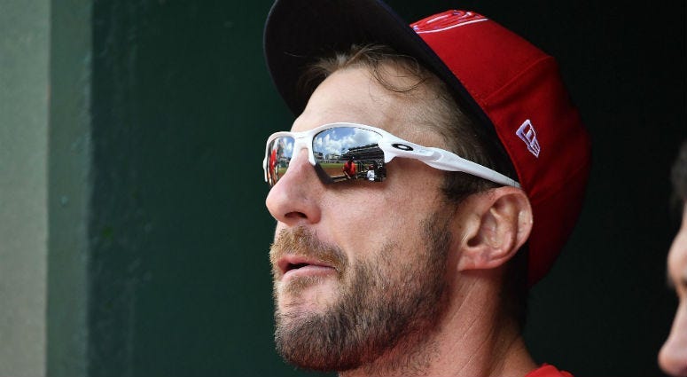 Nationals Max Scherzer stands in the dugout. 