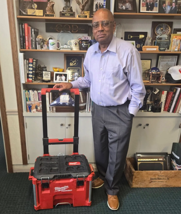 North Chicago Mayor Leon Rockingham, Jr with Toolbox he saw fall from truck and returned