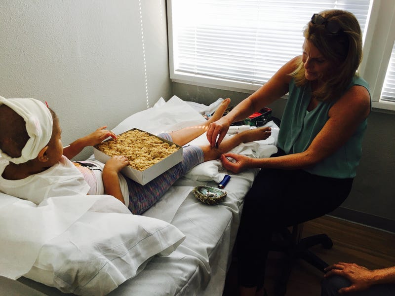 Dr. Ruth McCarty treating a young patient