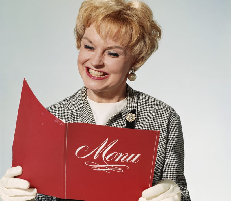 woman reading printed menu