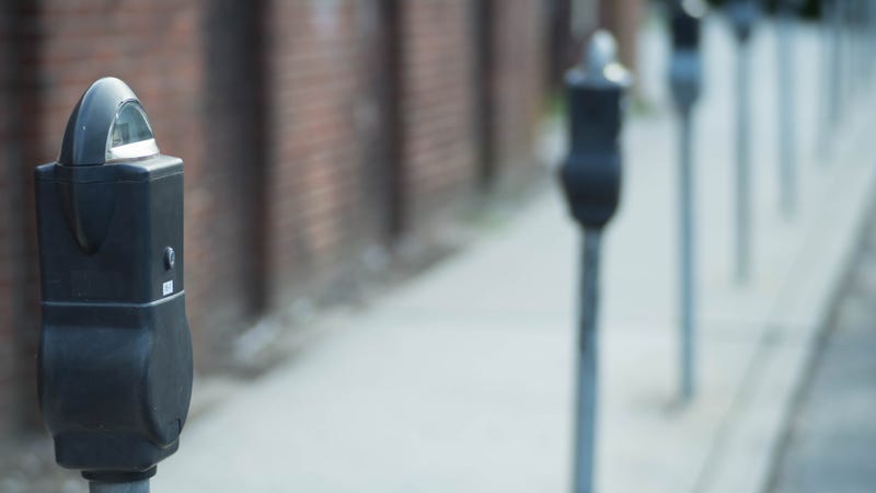 Parking meters in row on sidewalk - stock photo