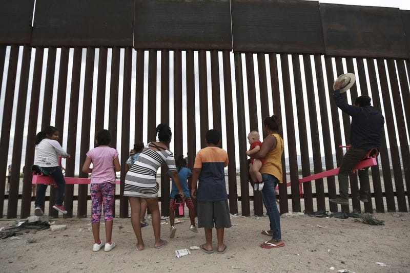 kids on seesaw at U.S. Mexico border