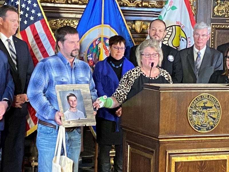 Michele Gran points to a picture of her son, Landon