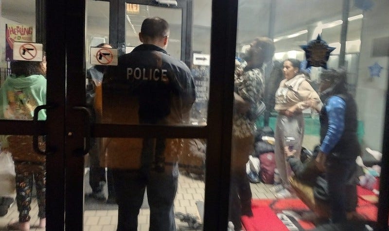 Migrants in police station lobby