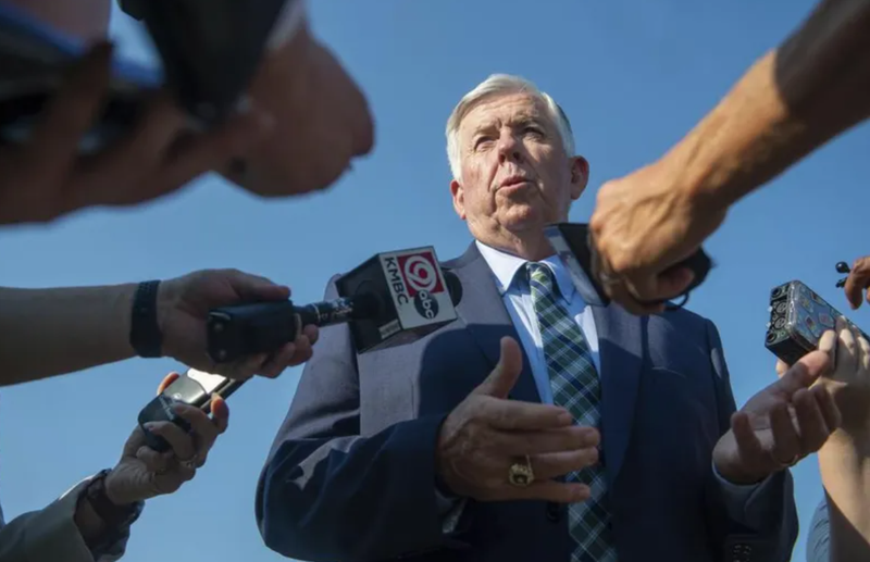 Governor Mike Parson with microphones in his face