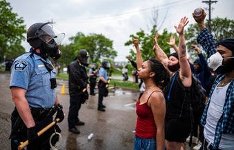 Protesters and police face each other during a rally for George Floyd in Minneapolis on Tuesday, May 26, 2020. (Richard Tsong-Taatarii/Star Tribune via AP)