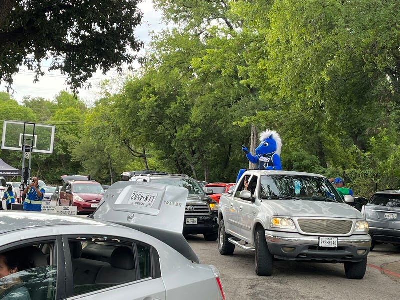 The Dallas Mavericks' mascot Champ helps hand out hydration kits on Tuesday, Aug. 1, 2023.