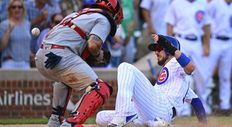 Jul 22, 2017; Chicago, IL, USA; Chicago Cubs third baseman Kris Bryant (right) slides safely into home plate to score against St. Louis Cardinals catcher Yadier Molina (left) in the eighth inning at Wrigley Field.Mandatory Credit: Patrick Gorski-USA TODAY