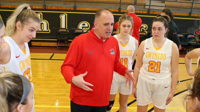 Gwynedd Mercy women's basketball coach Keith Mondillo (center) talks to players.