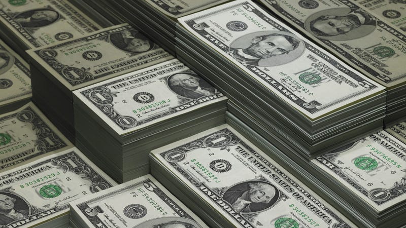 Piles of dollar bills reflected in glass - stock photo
