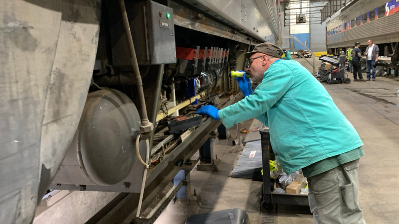 Man inspects one of SEPTA's 223 Silverliner IV rail cars