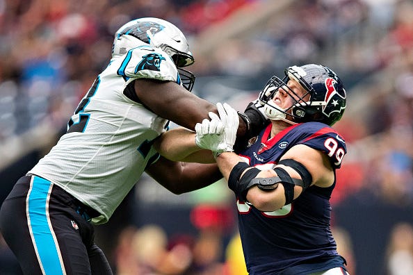 Taylor Moton stuffs J.J. Watt at the line of scrimmage. 