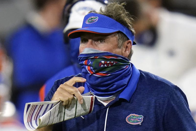 Florida head coach Dan Mullen, right, pauses during a timeout against Georgia during the second half of an NCAA college football game, Saturday, Nov. 7, 2020, in Jacksonville, Fla.
