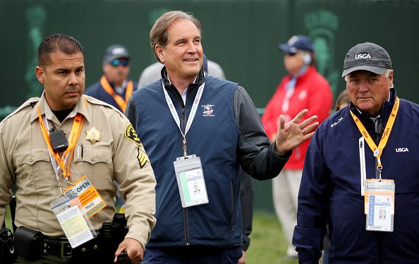 Jim Nantz walks at Pebble Beach