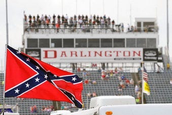 FILE - In this Sept. 5, 2015, file photo, a Confederate flag flies in the infield before a NASCAR Xfinity auto race at Darlington Raceway in Darlington, S.C. (AP Photo/Terry Renna, File)