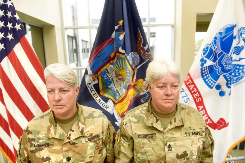 Lt. Col. Lynn Currier, an information management branch manager, and Master Sgt. Lisa Currier, a senior logistics officer, assigned to the New York National Guard Headquarters here, prepare for Lynn&apos;s retirement from the New York National Guard during a c