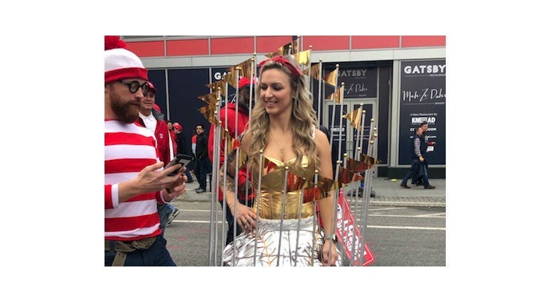 A woman dubbed, Mrs. World Series, dresses up as the Commissioner's Trophy before Game 4 at Nationals Park.