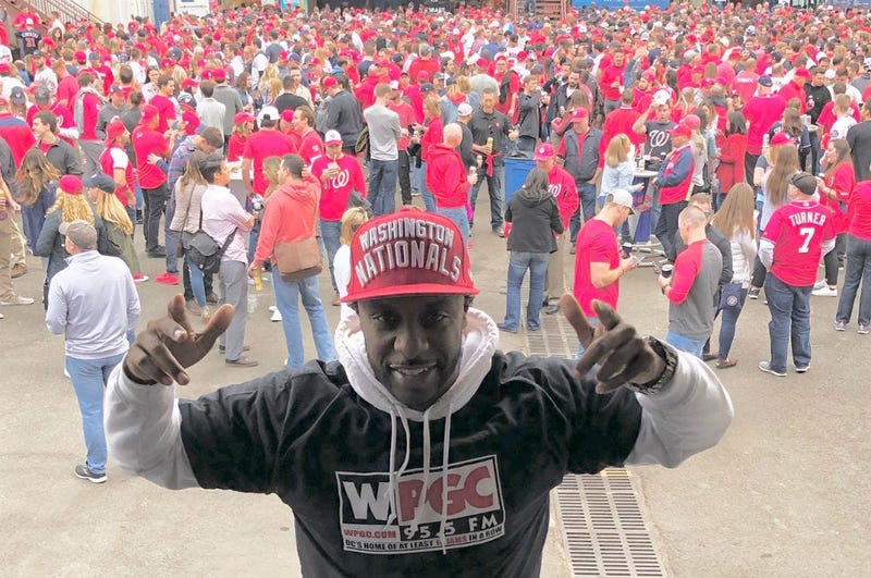 A sea of red behind WPGC's DJ AKADEMIKS during Game 3 pregame before the World Series at Nationals Park.