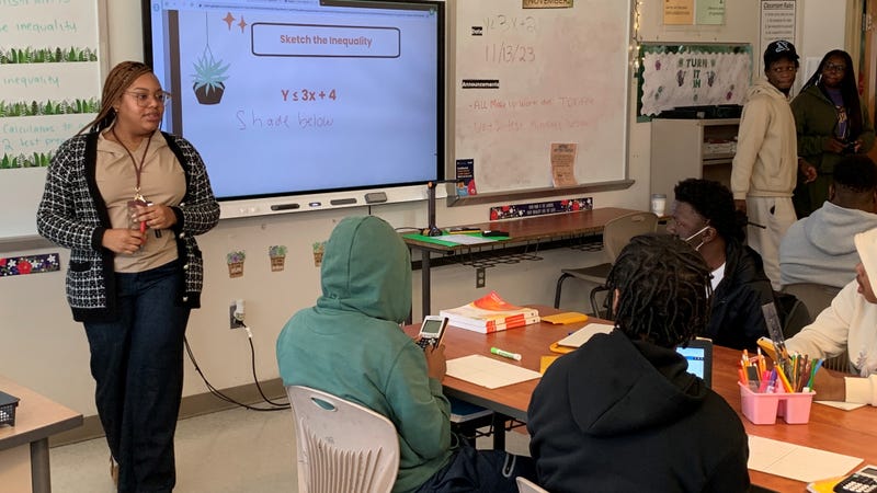 West Philadelphia High School math teacher Kacey Kelley stands in front of a classroom full of students.
