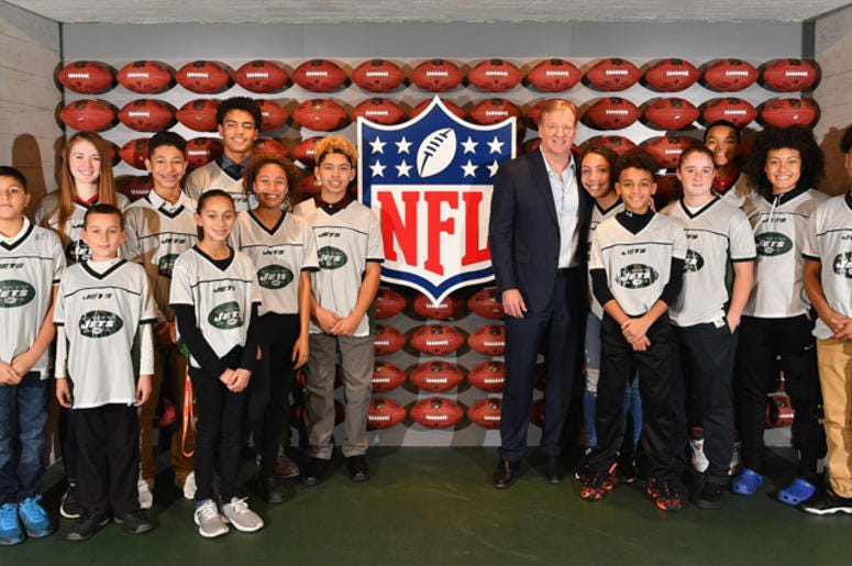 NFL Commissioner Roger Goodell poses for a photo with the Jets 13-14 girls and boys NFL flag champions during the NFL Experience Times Square opening celebration on Nov. 30, 2017. 