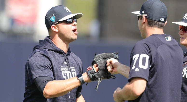 Yankees guest instructor Nick Swisher talks with center fielder Jake Cave during spring training on Feb. 20, 2008, at George M. Steinbrenner Field in Tampa, Florida.