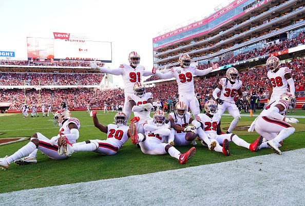 The San Francisco 49ers defense celebrates in the end zone. 