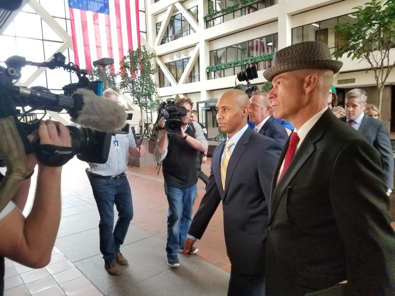 Officer Mohammed Noor (left) arrives with his attorney
