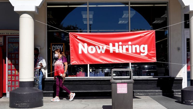 A Now Hiring sign hangs in front of a Winn-Dixie grocery store on December 03, 2021 in Miami, Florida.
