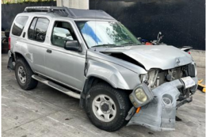 Silver 2004 Nissan Xterra with the front end smashed