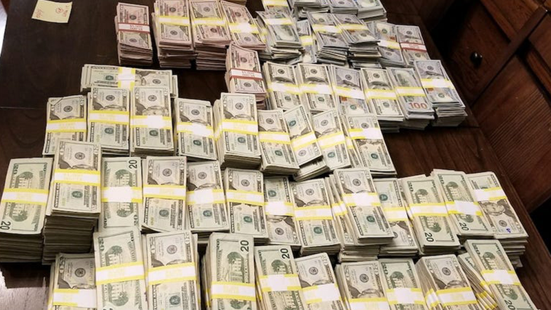 Piles of cash seized during a search of a New York nurse's home.